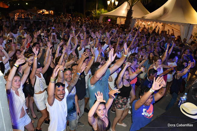 Crowd of people with hands up