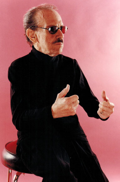Arturo "Chico" O'farrill dressed in black and with a red background