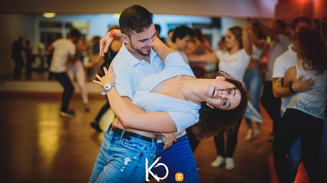 Couple dressed in white shirt and bluejeans dancing